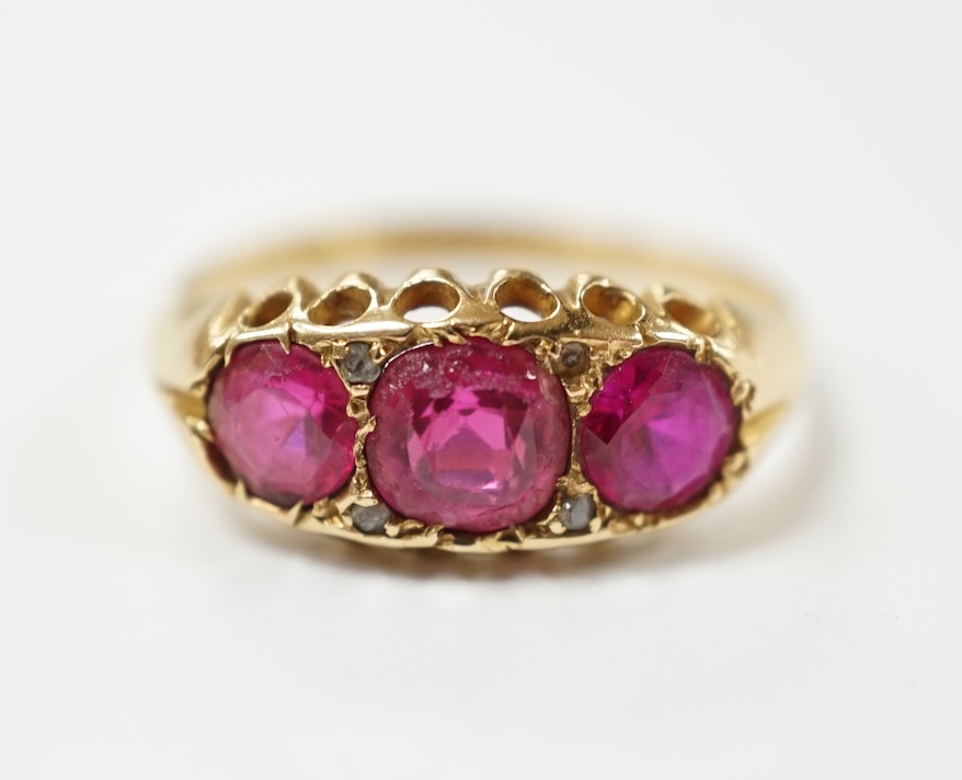 An Edwardian 18ct gold and three stone red doublet set ring, size L, gross weight 2.5 grams. Condition - fair